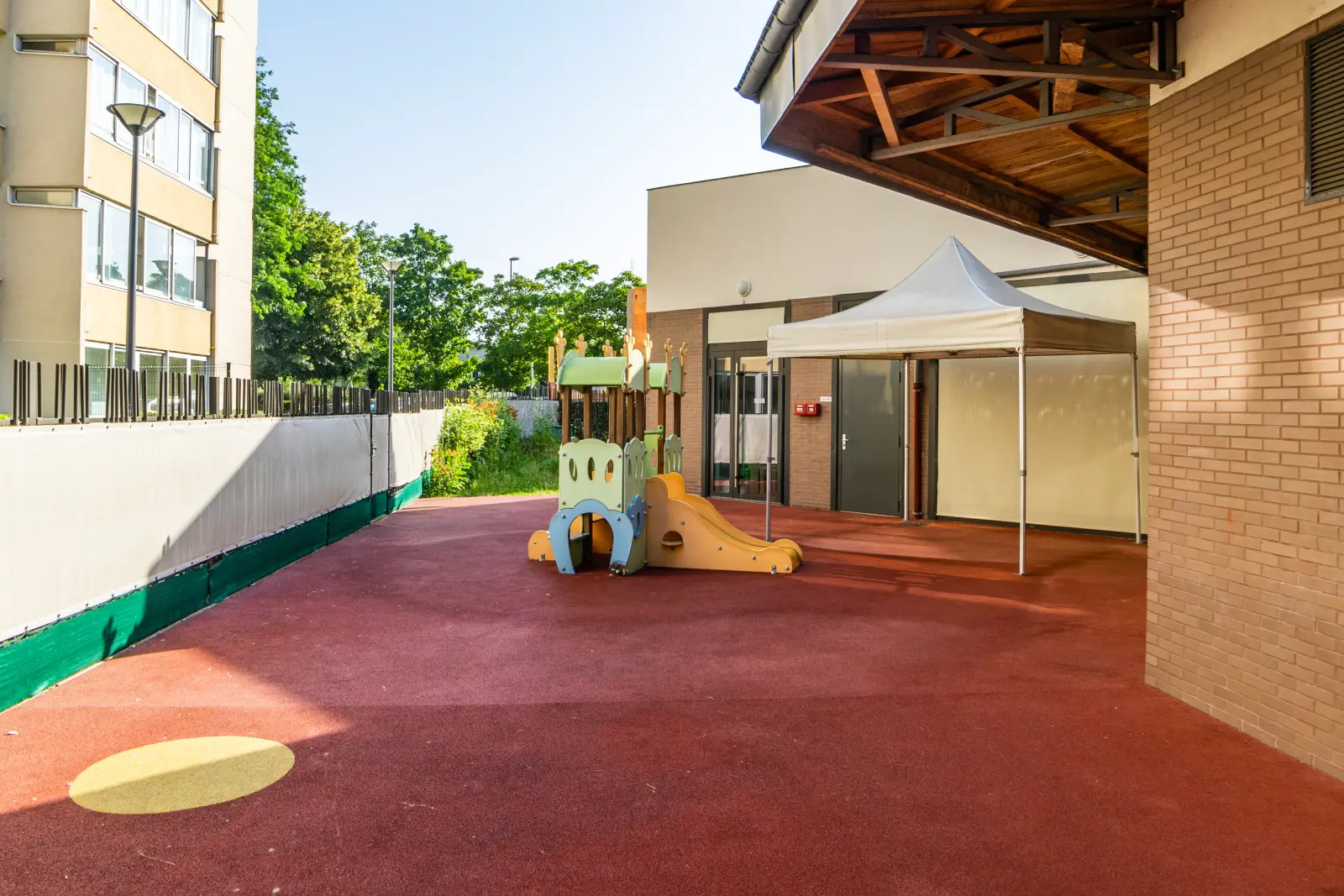 Cour extérieure équipée de jeux à la crèche Les P'tits Loups, Noisy-le-Grand