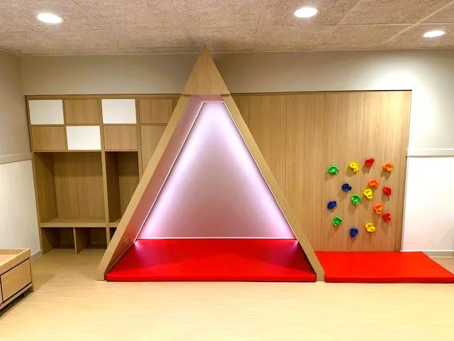 Structure en bois éclairée et mur d'escalade à la crèche Babilou de Choisy-le-Roi