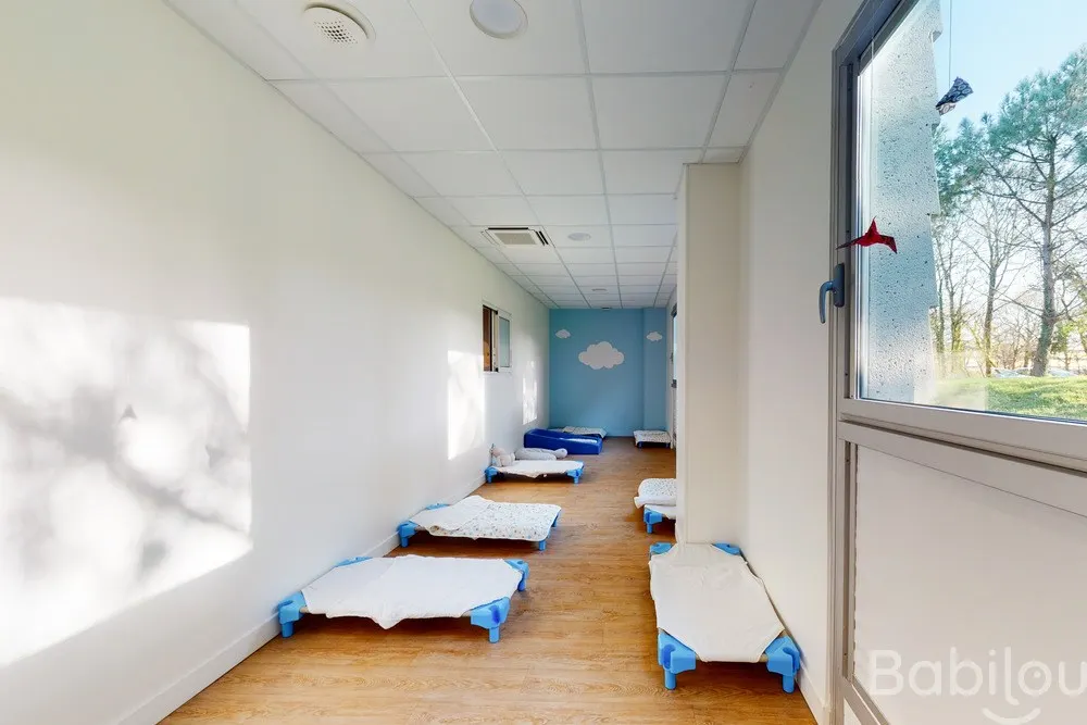 Dortoir décoré de nuages à la crèche Babilou Nantes Daguerre