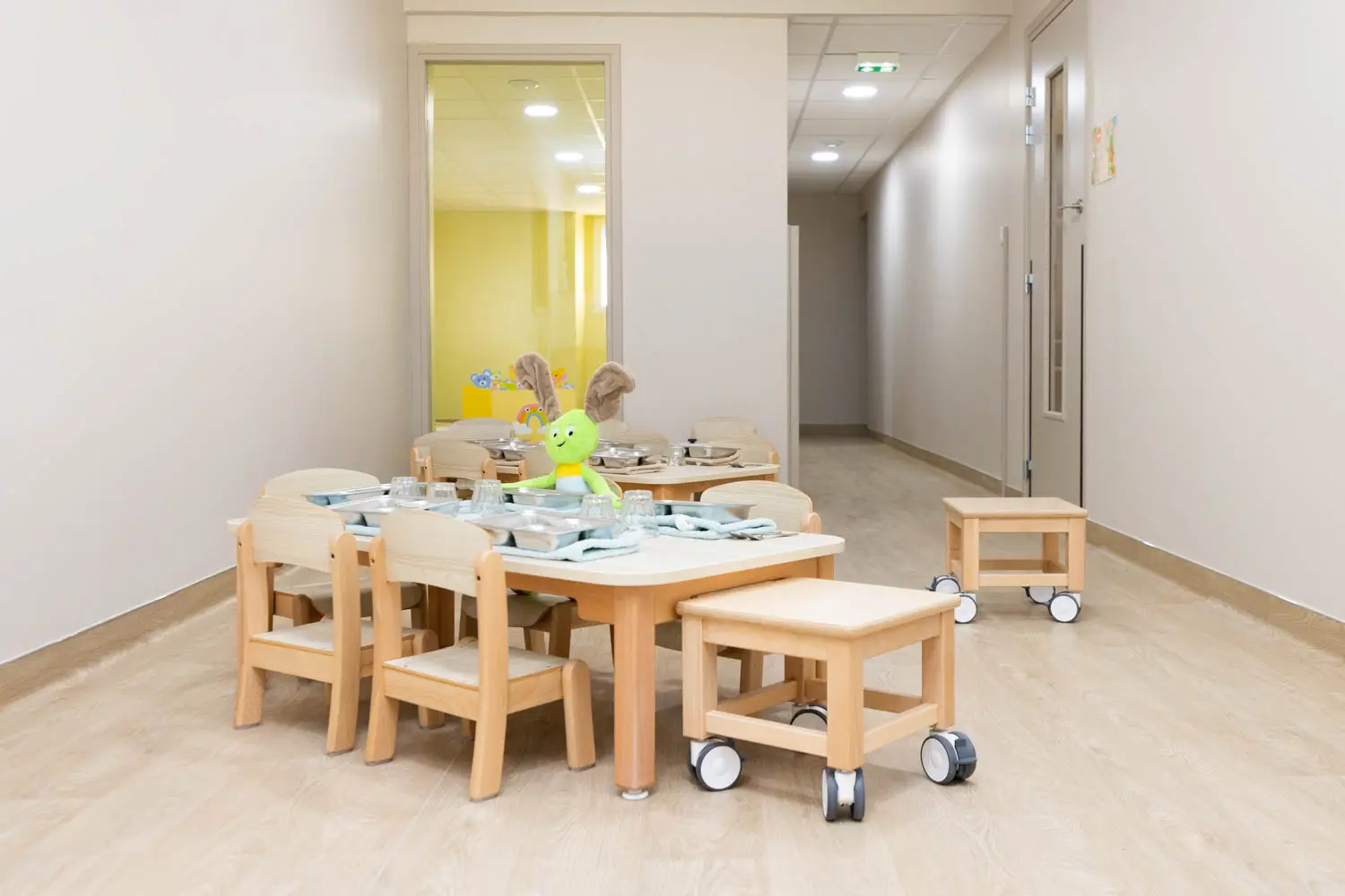 Espace repas avec petites tables et chaises à la micro-crèche de Montierchaume